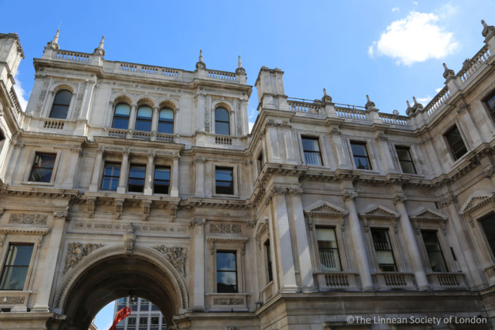 Burlington House, a three-storey, stone building with an archway and tall windows.