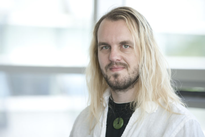 Portrait photograph of Rich Boden, Trustee of the Linnean Society, in a white lab coat