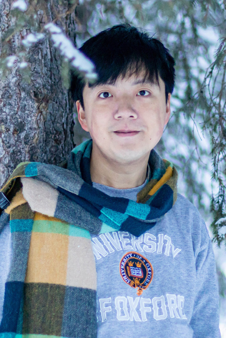 Dr Tin Hang (Henry) Hung leans against a tree in the snow