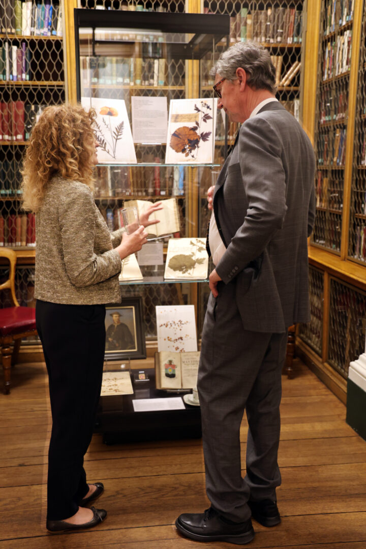 Gail Cardew and Vice Admiral Sir Tim Laurence viewing exhibits in the Linnean Society library