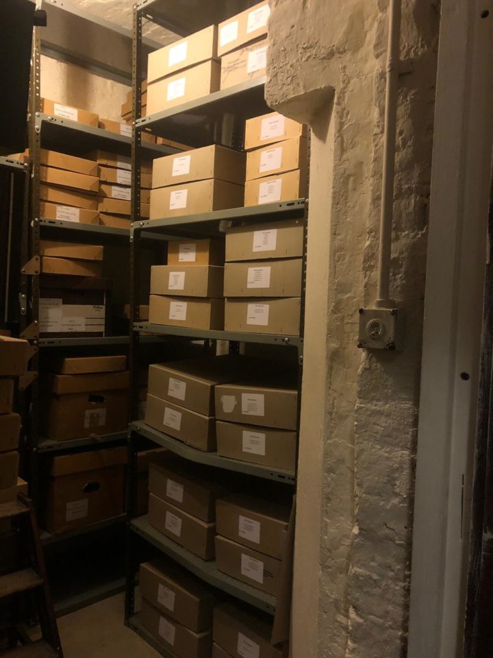 Archive boxes stacked on shelving in a store room