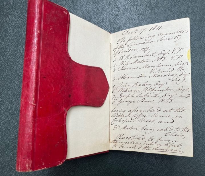 Notebook with red leather cover open on first page