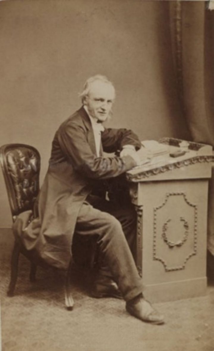 Sepia photograph of a man at a writing desk