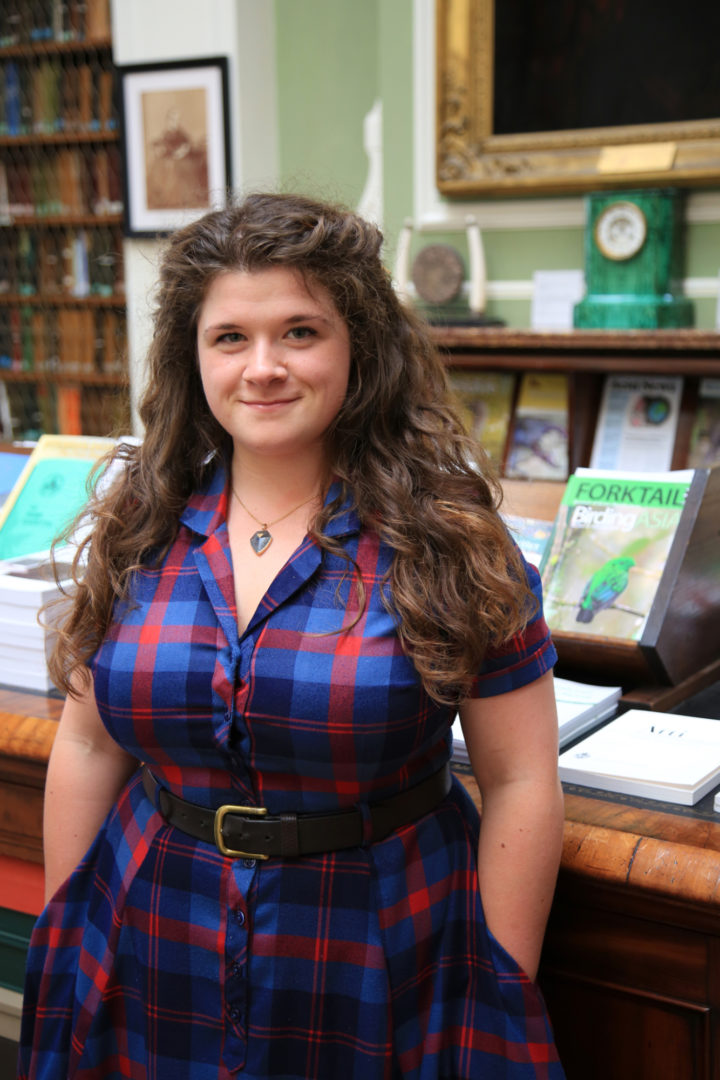 Photographic portrait of Alex Milne, archivist, stood in the library of the Linnean Society