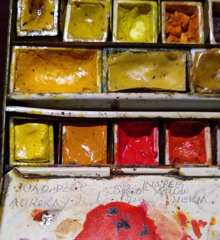 Close up of watercolour paint box: Yellow, Orange, Red