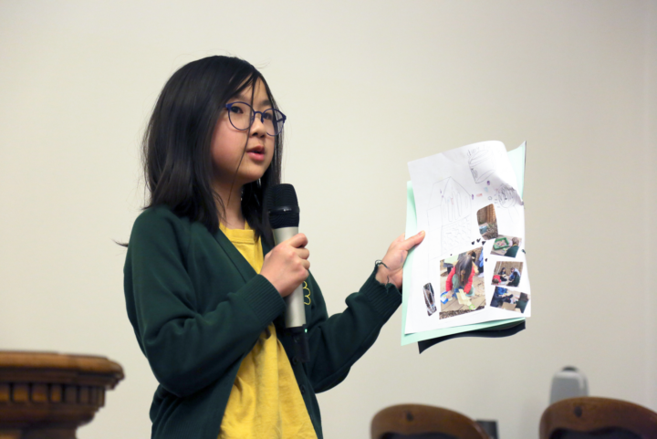 A student presenting their nature journal in the meeting room