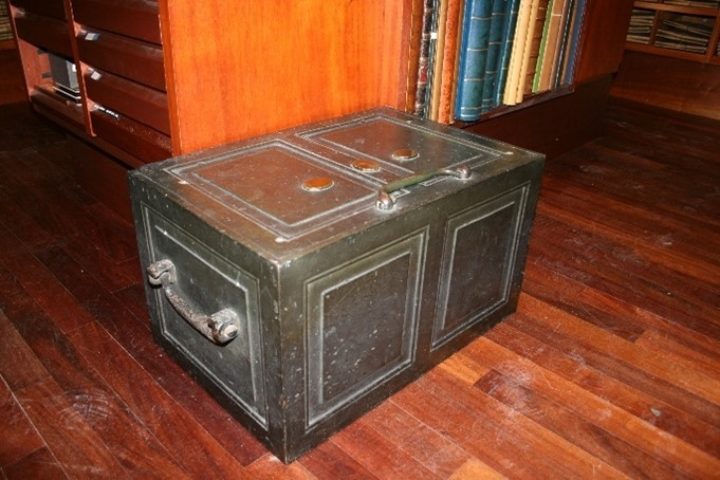 Photograph of the Iron Chest on wooden floor
