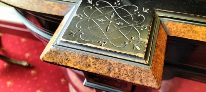 Photo showing detailed carving on the silver cabinet