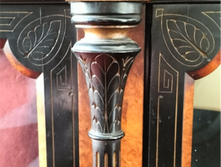 closeup of the carved leaf patterns on the silver cabinet