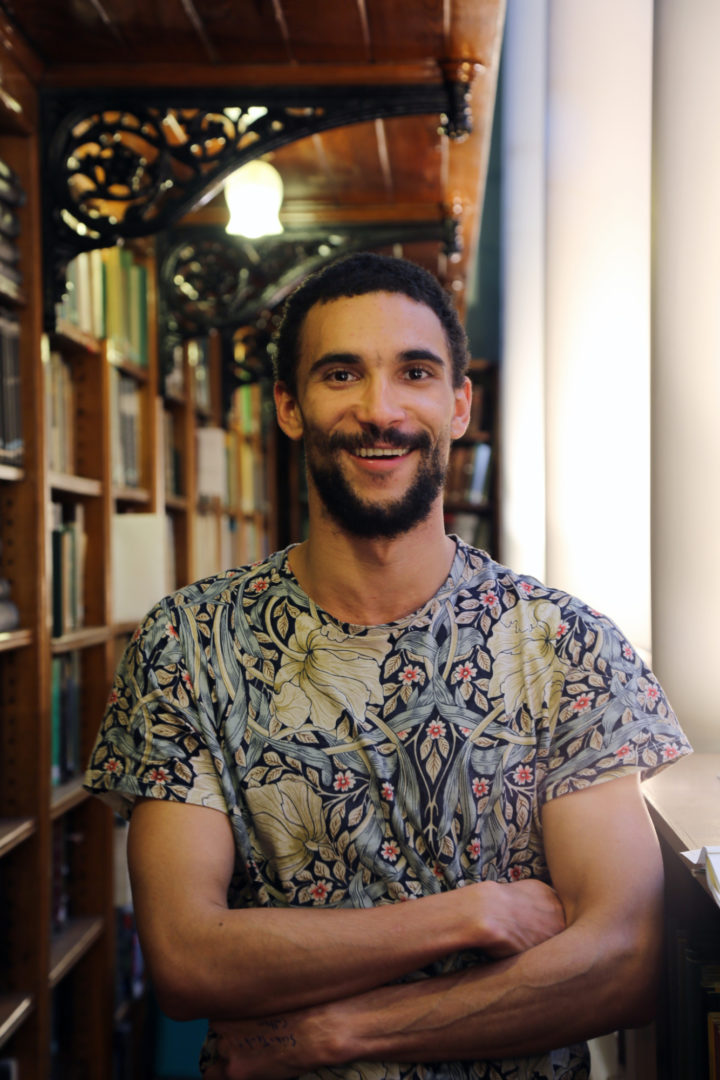 Photo portrait of Zia Forrai, Education Assistant at the Linnean Society, stood in the Society's library