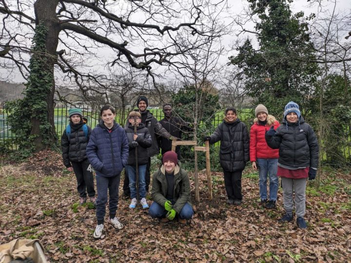 Young people from the Wave Project with their newly planted oak tree at Sydenham Hill Woods