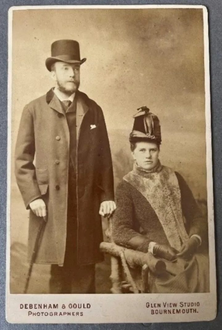 Sepia portrait image of Dukinfield Henry Scott (standing) and his wife Rina (seated).