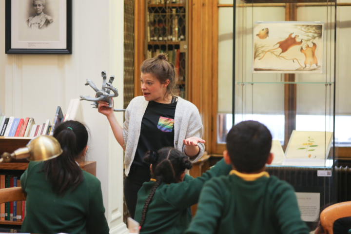 Workshop leader showing children a hydra model